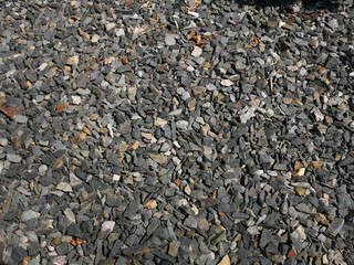 Texture of gray stones. Crushed stone is poured.