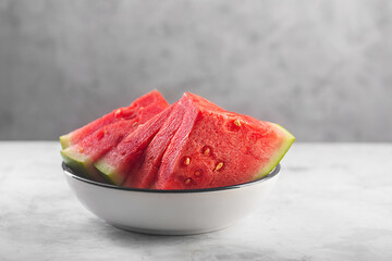 Large red raw watermelon pieces on gray background