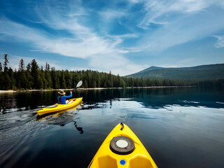 Couple in Yellow Kayaks on Calm Lake