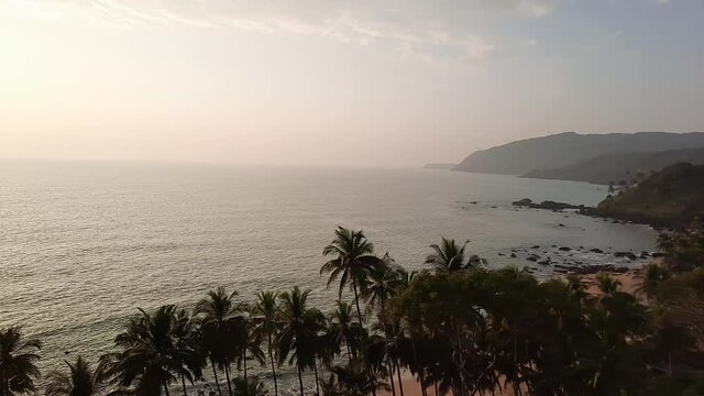 view of the goa sea coastline with sunset. goa beach. cola beach view over the mountain. 
