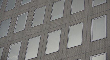 array of clean square reflective film one way glass windows modern building facade