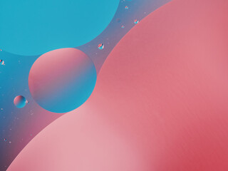 Closeup of oil drops motion on water surface. Colorful abstract macro background of oil drops on water surface with air bubbles inside