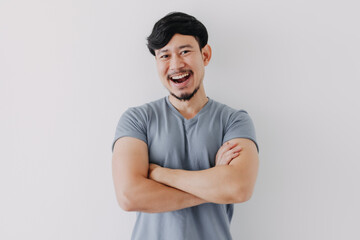 Confident and happy Asian man in blue t-shirt isolated on white background.