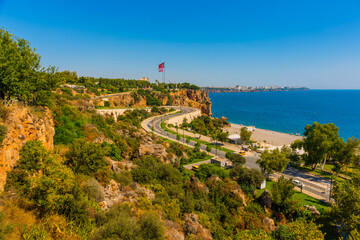 Fototapeta na wymiar ANTALYA, TURKEY: Serpentine road leads to Konyaalti beach on a sunny summer day in Antalya.