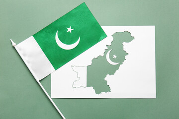 Paper sheet with map and flag of Pakistan on color background