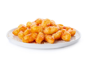 Plate with tasty gnocchi on white background