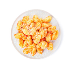 Plate with tasty gnocchi on white background
