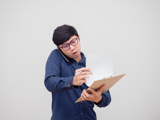 Asian man busy talking with mobile phone and finding document board in hand white background