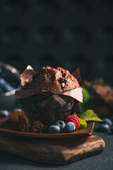 Chocolate muffin. Muffin with chocolate and fruits. Fruit muffin. - obrazy, fototapety, plakaty
