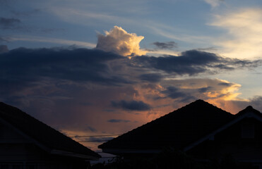 beautiful Blue sky and white clouds in sunset,copy space,the roof of house on foreground.