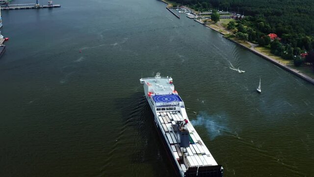 Cargo Ship With Helipad Sailing At The Port Of Klaipeda In Lithuania, aerial tilt-up