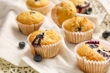 Tasty blueberry muffins on table, closeup