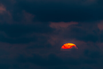 Colorful sun in the clouds background