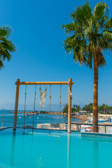 ANTALYA, TURKEY: Swimming pool and swing on the territory of Fosforlu beach on a sunny day.