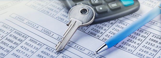 Real estate and investment concept. Calculator with finance blank, key and pen.