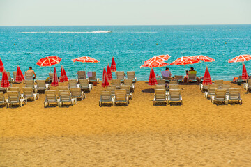 ANTALYA, TURKEY: Sun loungers and umbrellas on the Lara beach on a sunny summer day in Antalya.