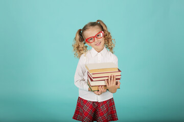 a beautiful blonde schoolgirl girl with ponytails in a white shirt a red plaid skirt with checks...