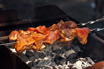 Slice pieces of meat on the grill. barbecue at the festival. Cheese and roasted veal on skewers.