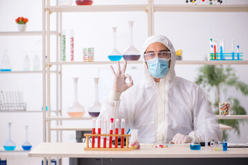 Young male chemist in drugs syntesis concept