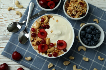 Concept of tasty breakfast with yogurt on wooden table