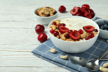 Concept of tasty breakfast with yogurt on wooden table