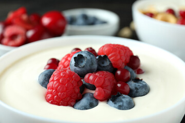 Bowl of tasty berry yogurt, close up