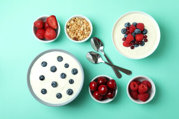 Concept of tasty breakfast with yogurt on mint background