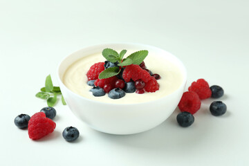 Concept of tasty breakfast with yogurt on white background