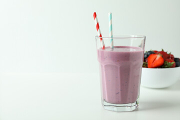 Glass of smoothie and ingredients on white background