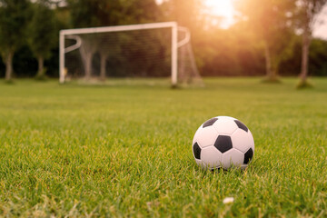 Fototapeta na wymiar White soccer of football goal post on a grass field of a training ground.
