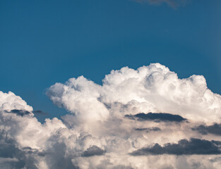 Naklejka na ściany i meble Dramatic cumulus clouds and above the clouds blue clear sky.