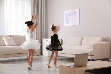 Cute little girls taking online dance class at home