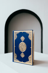 The Qur'an is the holy book in Islam against the background of the white arch