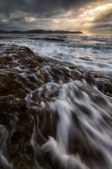 water flowing on the rocks at the beach