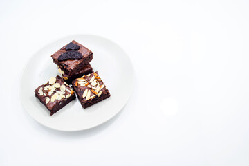Brownie in dish on white background.