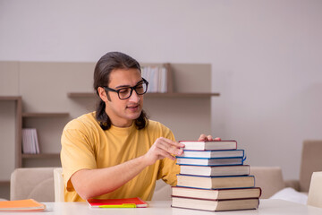 Young male student preparing for exams at home