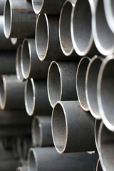 Stack of metal, steel pipes on warehouse