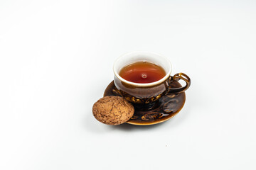 blue cup with tea and cookies, on a white background, vintage style. it's time to drink tea
