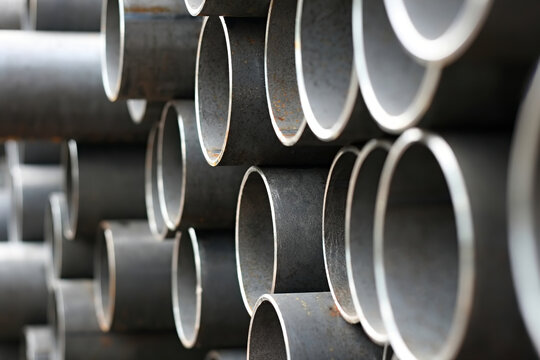Stack of metal, steel pipes on warehouse
