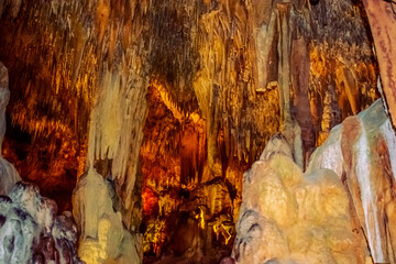 Many mineral formations inside Damlatas cave in Alanya (Turkey). Orange-yellow-brown natural pattern with stone thorns