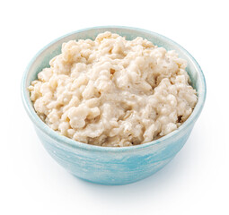 Oatmeal porridge in blue bowl. Porridge isolated on white background. Bowl of porridge for package design.
