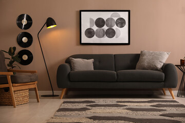 Stylish living room interior with comfortable dark sofa
