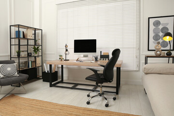 Home office interior with comfortable workplace near window