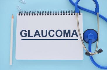 GLAUCOMA word written in Notebook. GLAUCOMA text on light bluebckground for your desing, concept.