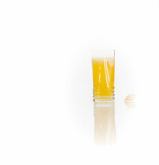 glass of multivitamins on white