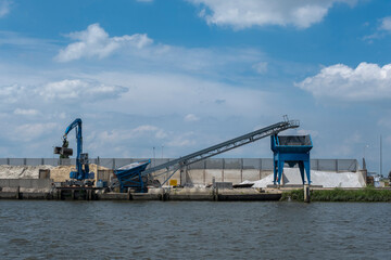 Fototapeta na wymiar The bulk cargo loaded in port - sand for construction
