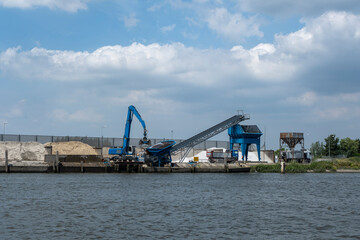 Fototapeta na wymiar The bulk cargo loaded in port - sand for construction