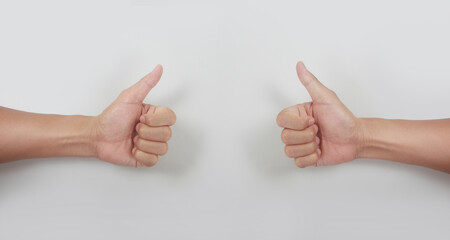 Male hand showing thumbs up sign against