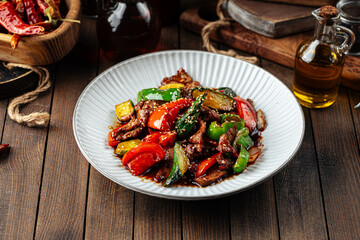 Chinese warm beef salad with vegetables and sesame seeds