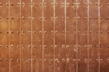 Texture of old copper plate door. Old castle gate background